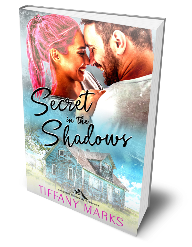 Secret in the Shadows by Tiffany Marks. A couple laughs together under soft light, the woman’s pink hair vivid against a weathered blue house in the background. A romantic suspense set in Spring Bluff, Montana, filled with secrets, danger, and redemption.